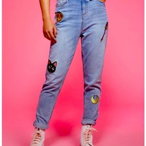 Pink,Yellow,Red, and Blue Sailor Moon jeans woth a little stain on it.